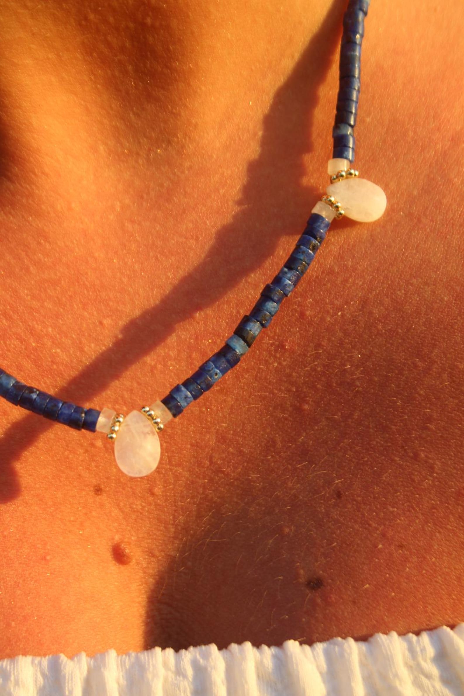Detail of deep blue lapis lazuli and glowing moonstone with soft light reflections