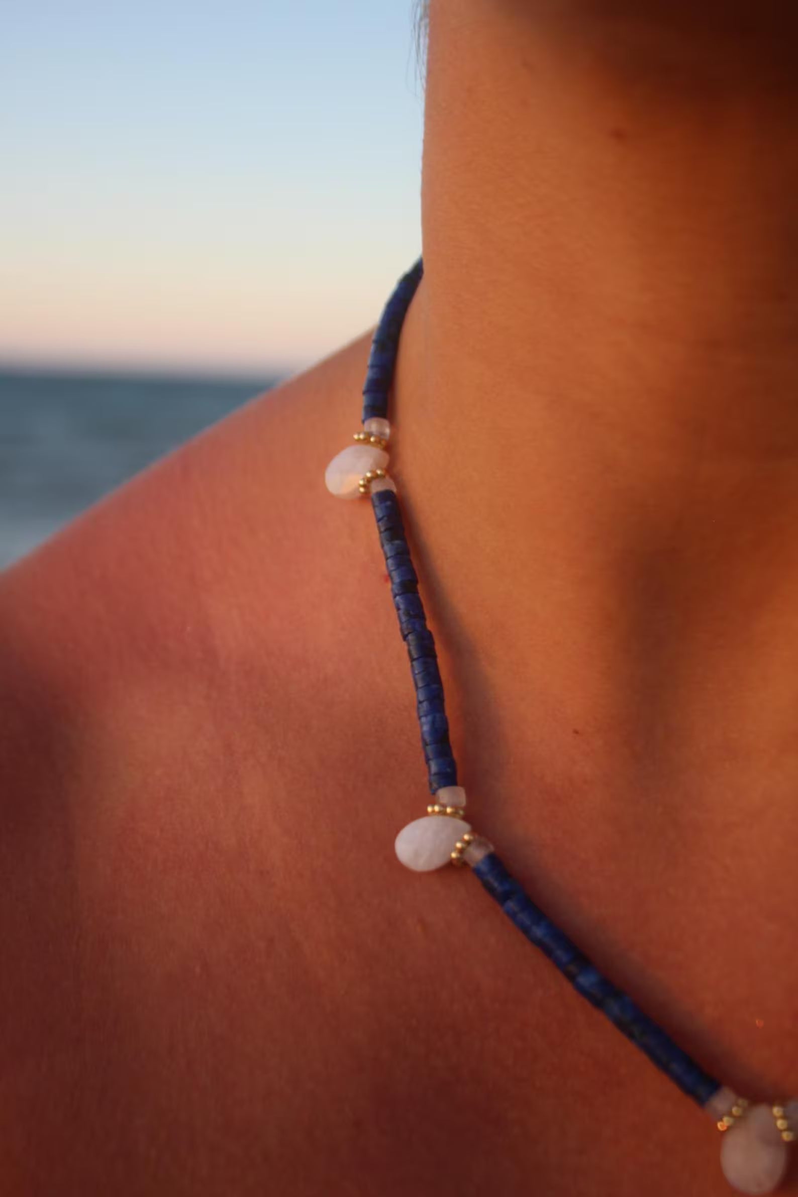 Close-up of natural lapis lazuli beads and moonstone pendant with soft iridescence